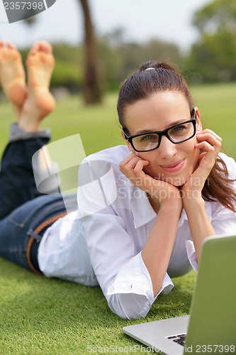 Image of woman with laptop in park