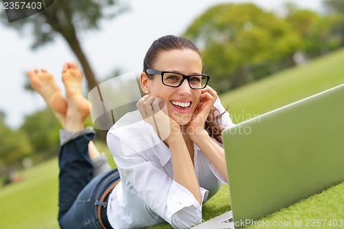 Image of woman with laptop in park
