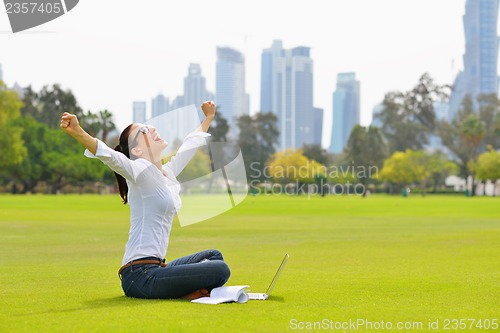 Image of woman with laptop in park