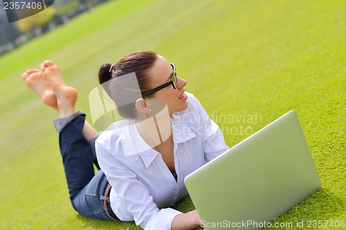 Image of woman with laptop in park