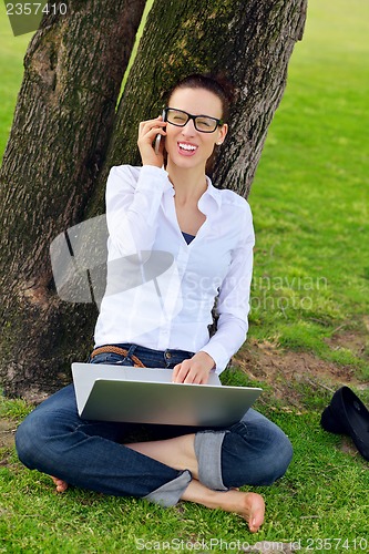 Image of woman with laptop in park