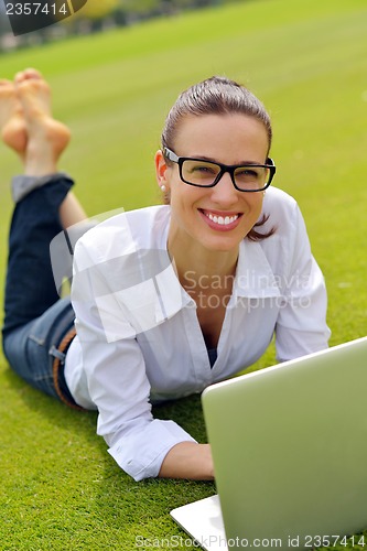 Image of woman with laptop in park