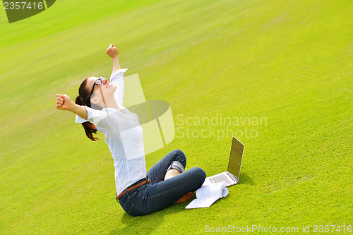 Image of woman with laptop in park