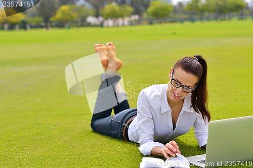 Image of woman with laptop in park