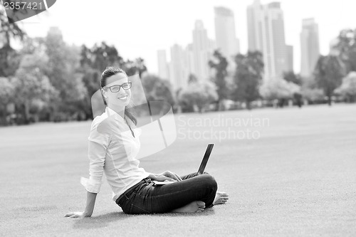 Image of woman with laptop in park