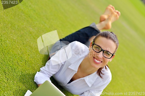 Image of woman with laptop in park