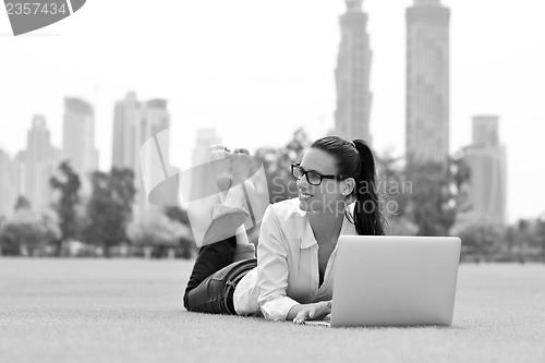 Image of woman with laptop in park