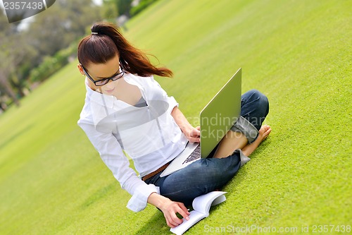 Image of woman with laptop in park