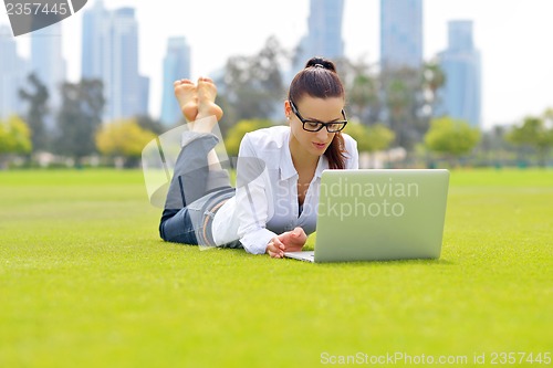 Image of woman with laptop in park