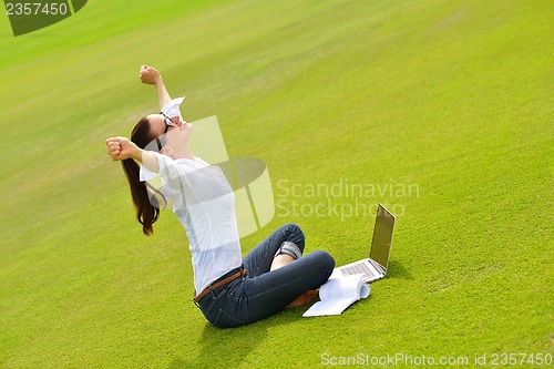 Image of woman with laptop in park
