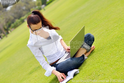 Image of woman with laptop in park