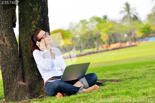 Image of woman with laptop in park