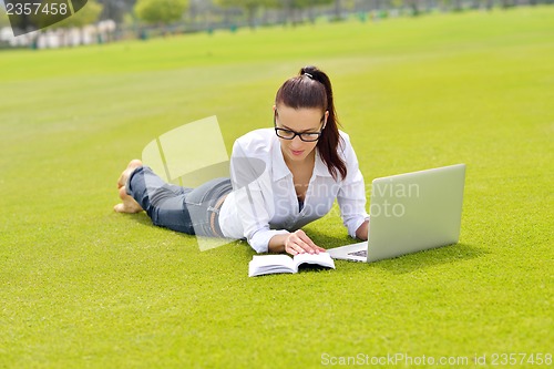 Image of woman with laptop in park