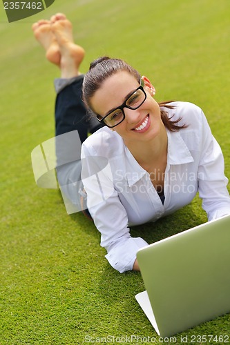 Image of woman with laptop in park