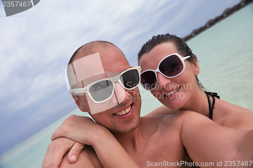 Image of happy young  couple at summer vacation have fun and relax at bea