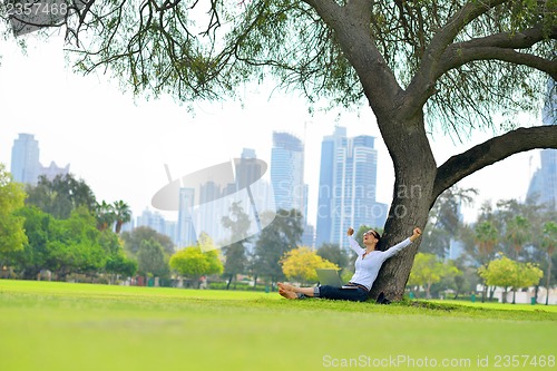 Image of woman with laptop in park