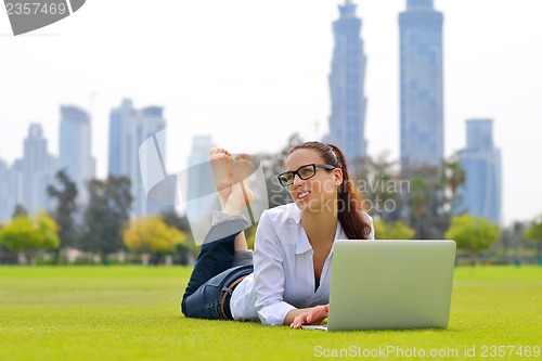 Image of woman with laptop in park