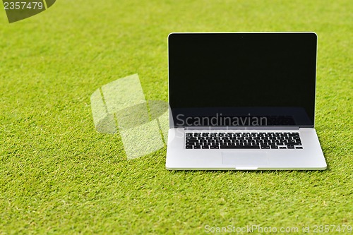 Image of laptop computer  on grass