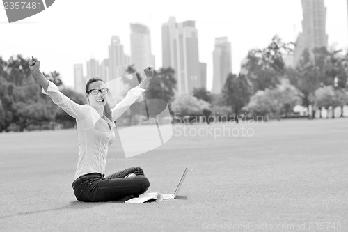 Image of woman with laptop in park