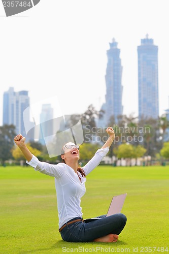 Image of woman with laptop in park