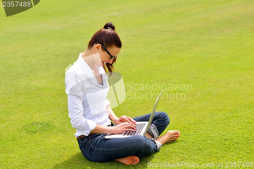 Image of woman with laptop in park