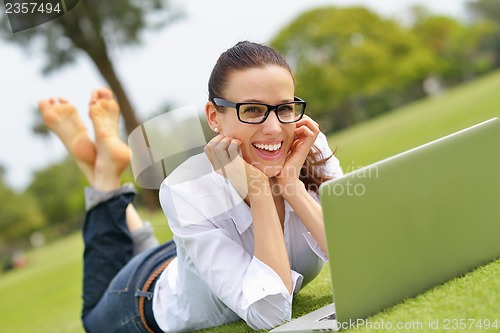 Image of woman with laptop in park