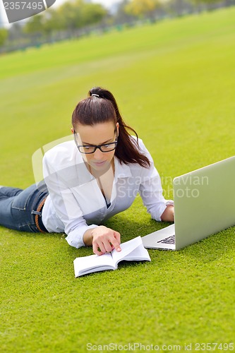 Image of woman with laptop in park