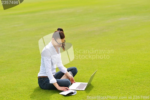 Image of woman with laptop in park