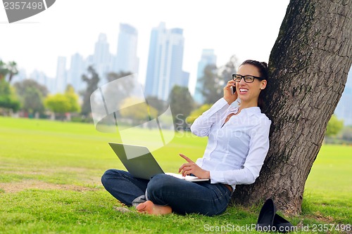 Image of woman with laptop in park