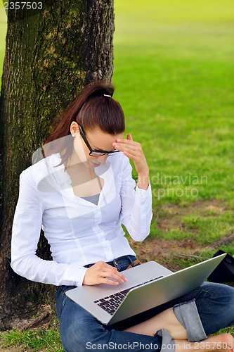 Image of woman with laptop in park