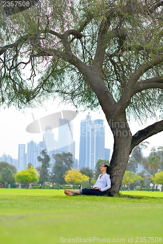 Image of woman with laptop in park