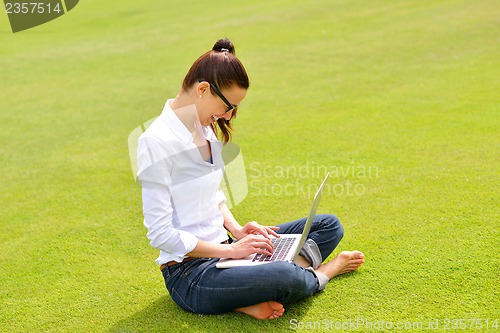Image of woman with laptop in park