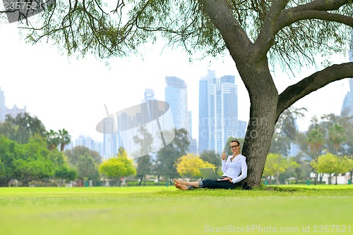 Image of woman with laptop in park