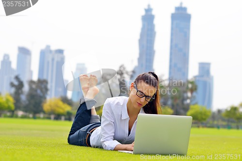 Image of woman with laptop in park
