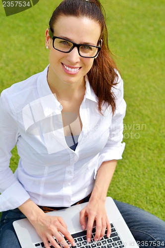 Image of woman with laptop in park