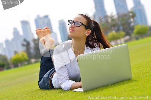 Image of woman with laptop in park
