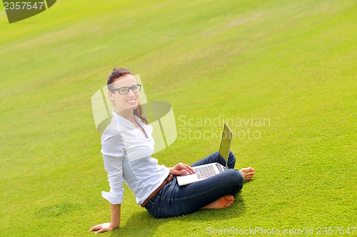 Image of woman with laptop in park