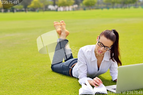 Image of woman with laptop in park
