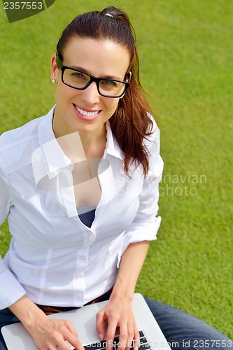 Image of woman with laptop in park