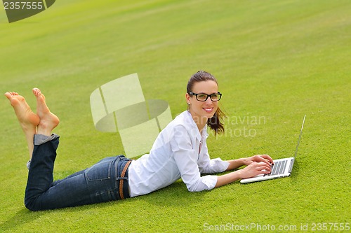 Image of woman with laptop in park