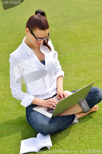 Image of woman with laptop in park