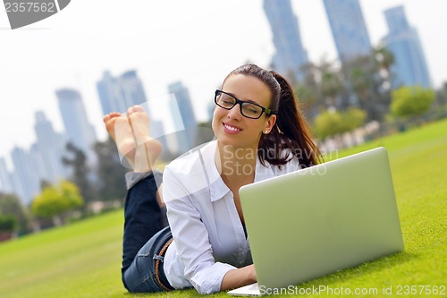 Image of woman with laptop in park