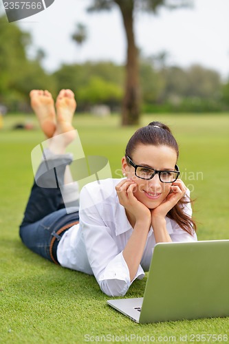 Image of woman with laptop in park