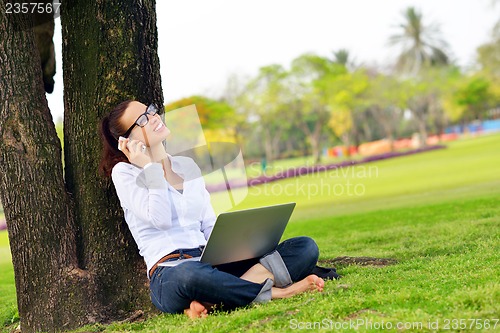 Image of woman with laptop in park