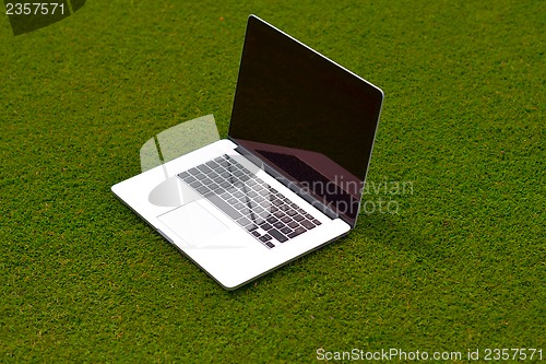 Image of laptop computer  on grass