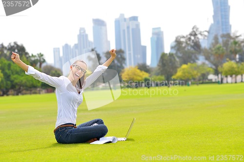 Image of woman with laptop in park