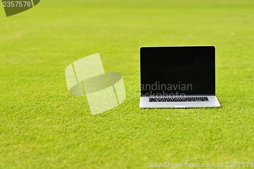 Image of laptop computer  on grass