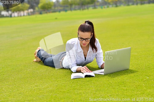 Image of woman with laptop in park
