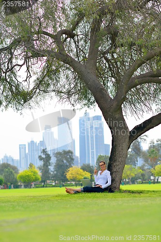 Image of woman with laptop in park