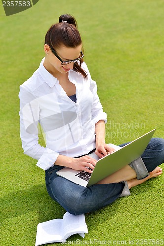 Image of woman with laptop in park